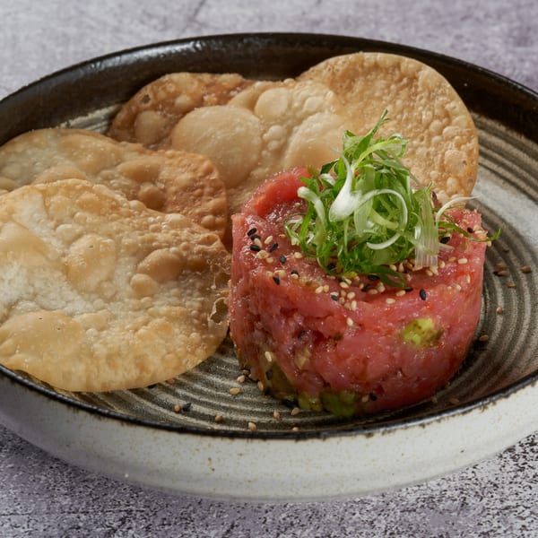 KEI's tuna tartare with avocado, sesame seeds, scallions, and crispy fried wonton chips.